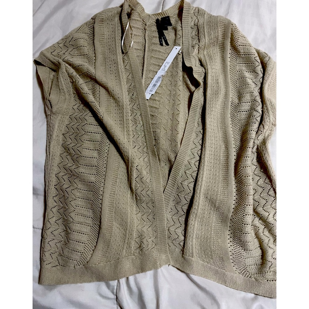 So it is brand. Crochet cardigan size large never worn. Beige